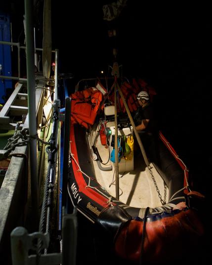Sea Punk I's RHIB Molly being launched in the night