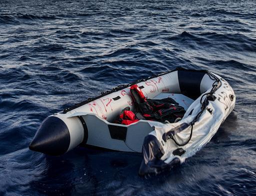 unseaworthy rubber boat with remaining life vests in the mediterranean sea