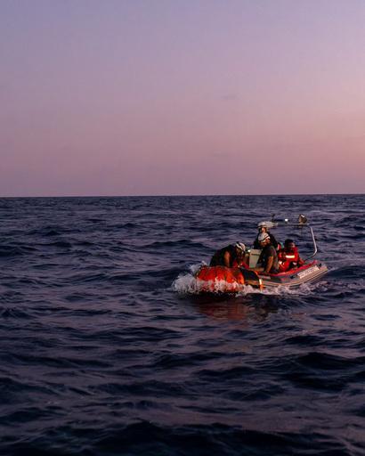 RHIB comes back to ship Sea Punk I with rescued survivors